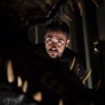 J.A. Bayona staring into a dinosaur's mouth